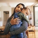 Mother holding her child in a room