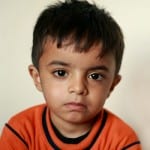 Little boy wearing an orange t-shirt